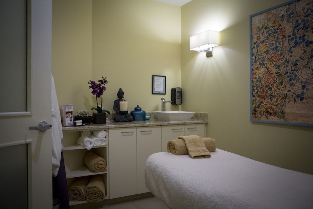 A tranquil spa room with a massage table and calming decor.
