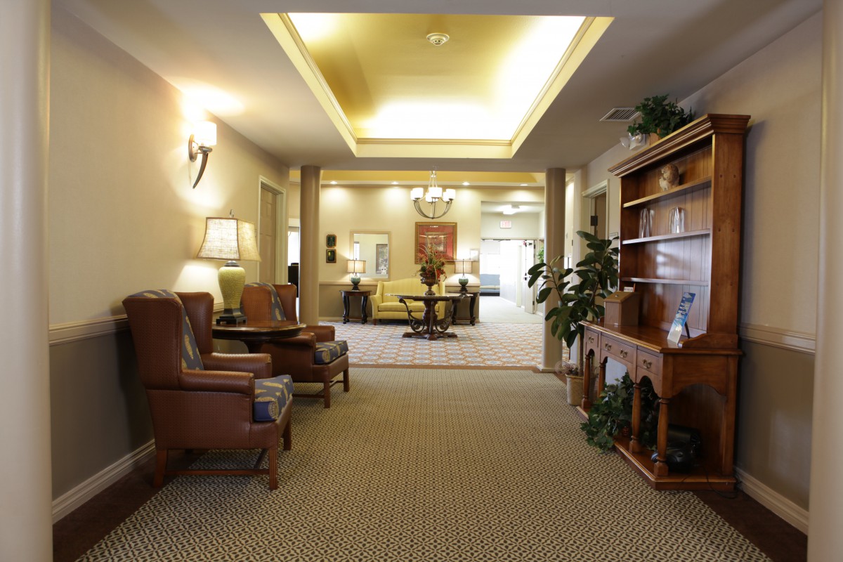 A well-lit lobby featuring comfortable seating and elegant decor.