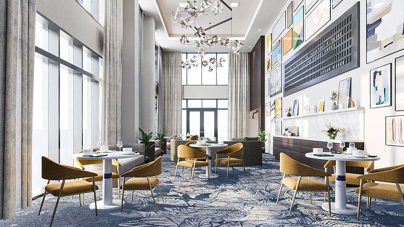 A modern lounge area featuring elegant chandeliers, stylish furnishings, and large artwork on the walls.