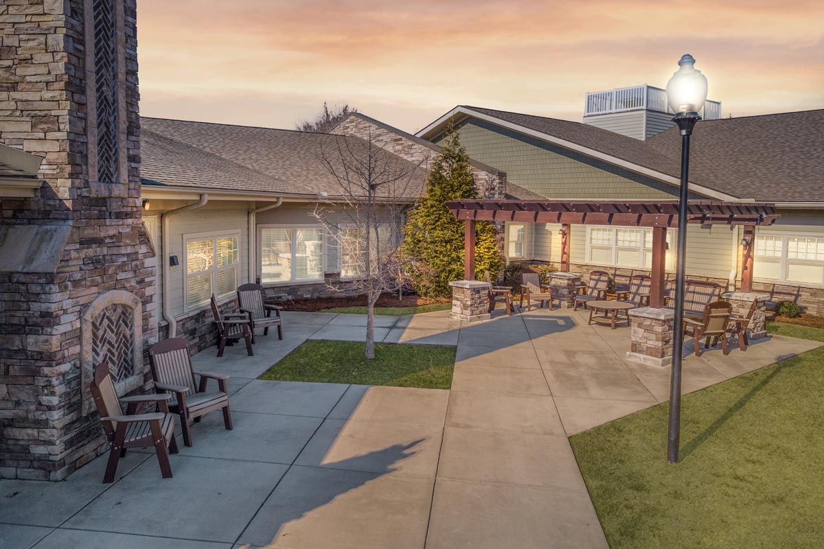 A serene courtyard with outdoor seating at sunset.