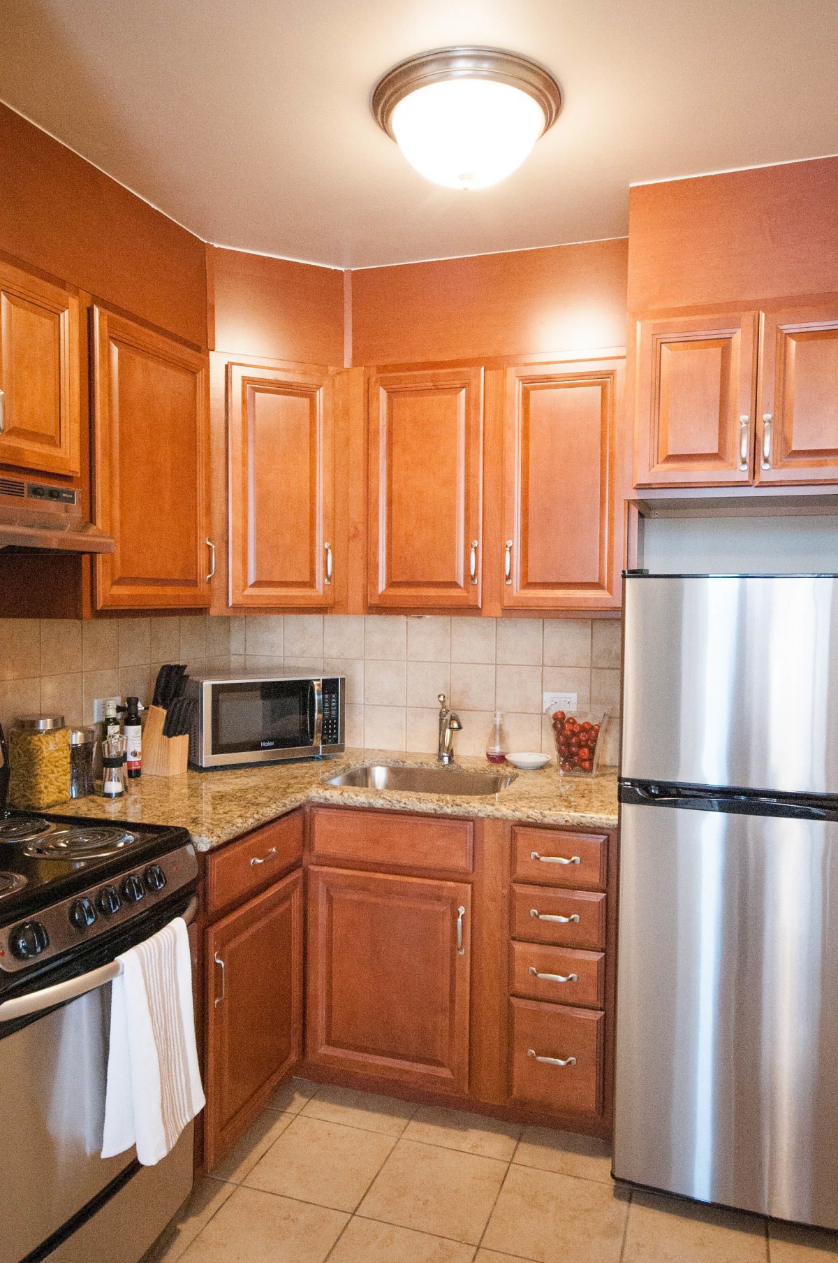 Modern kitchen with wooden cabinets and stainless steel appliances.