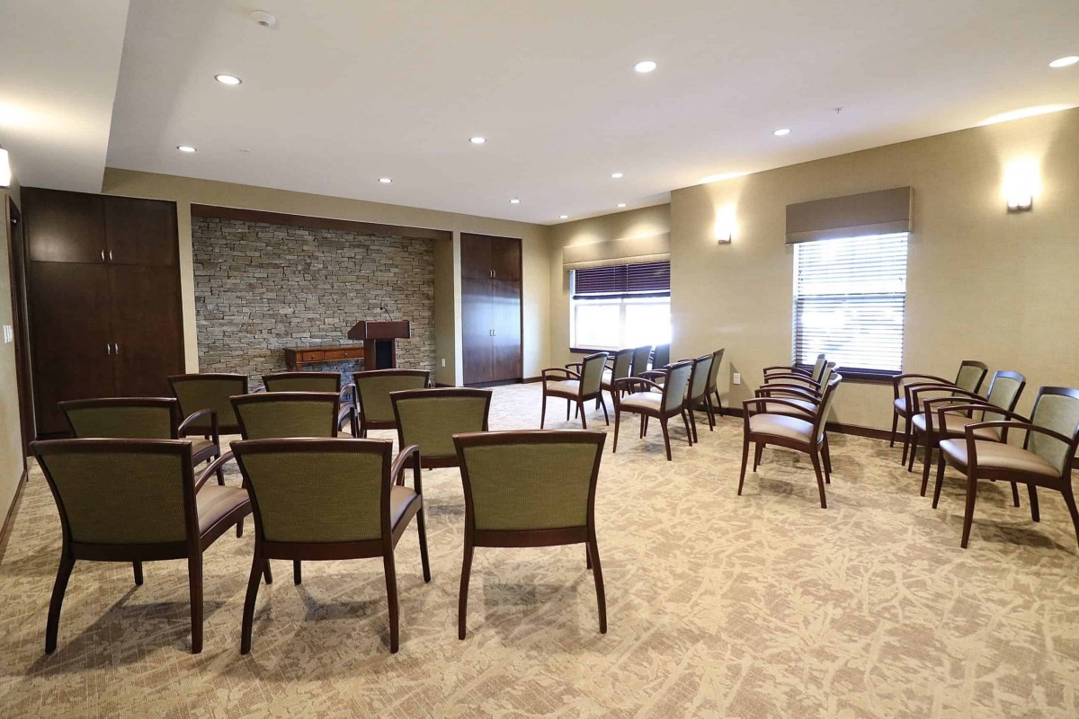 A conference room with arranged chairs and a podium.