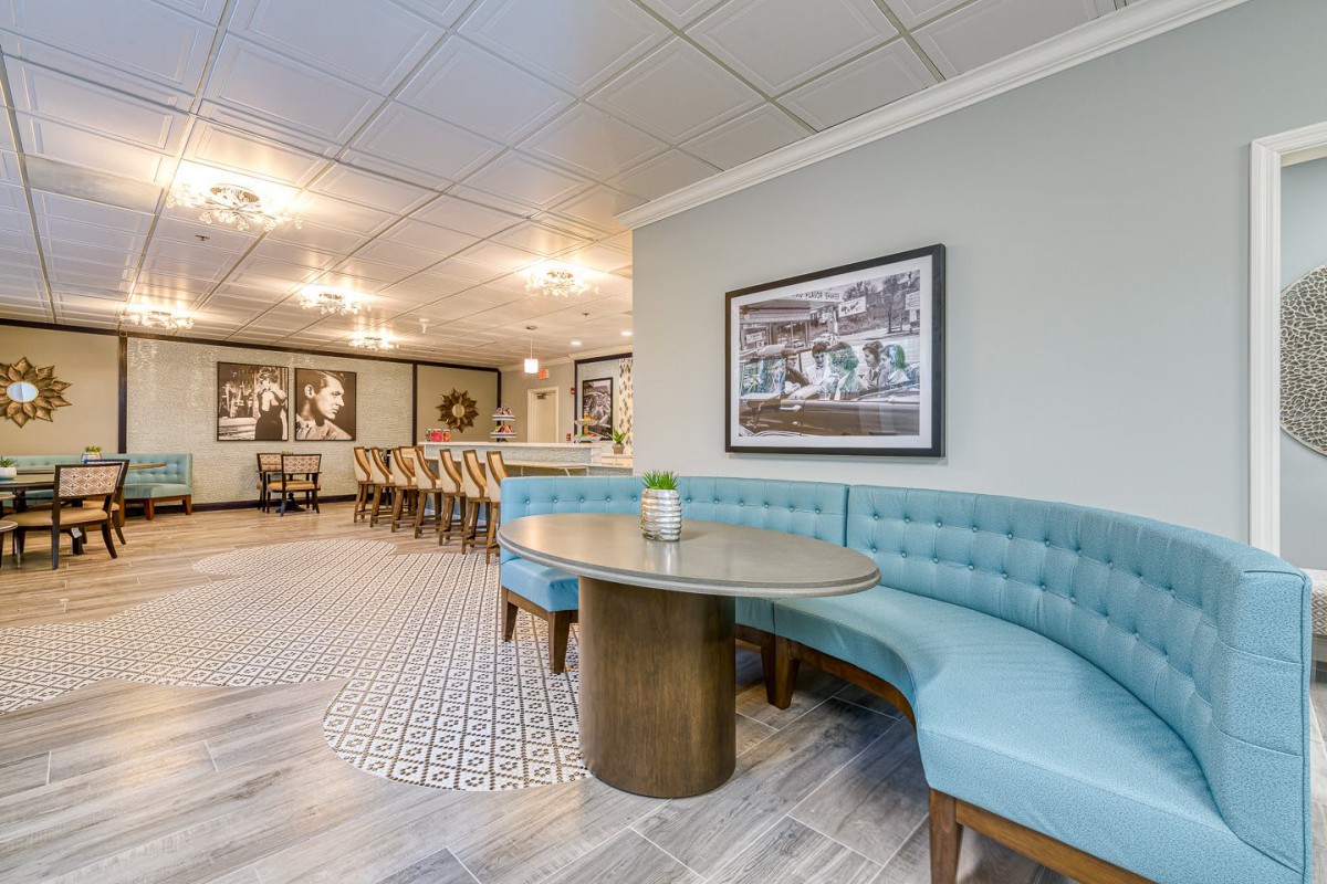 Modern dining area with stylish booth seating and framed artwork.