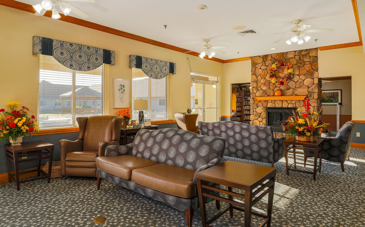 A cozy living room with comfortable seating and a warm fireplace.