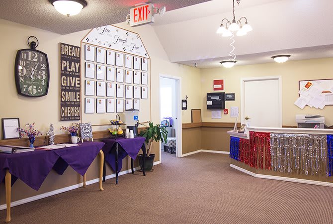A welcoming reception area with awards displayed on the wall and a neatly arranged waiting space.