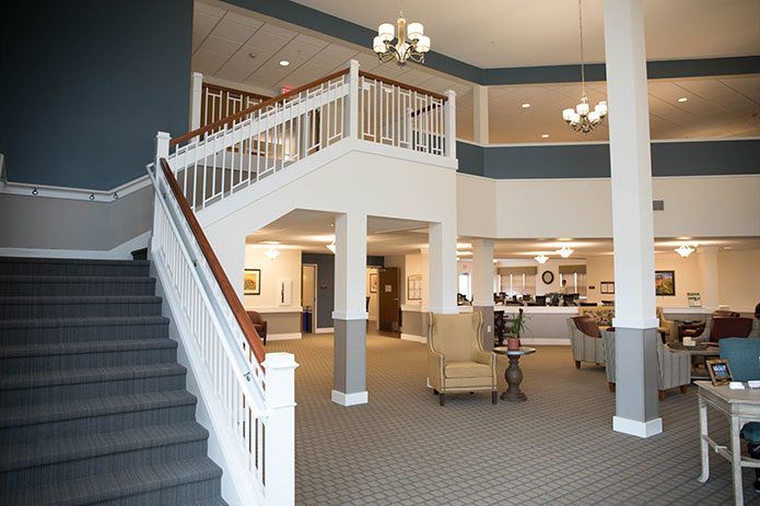 A spacious hotel lobby with a grand staircase and elegant lighting.