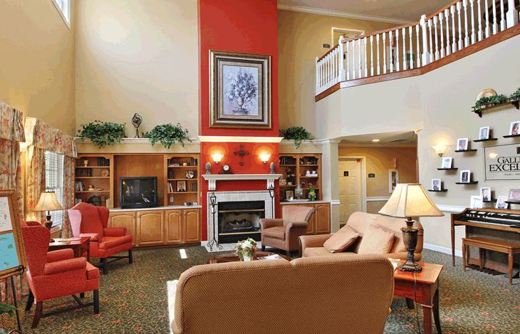 A cozy living room featuring a fireplace, comfortable seating, and elegant decor.