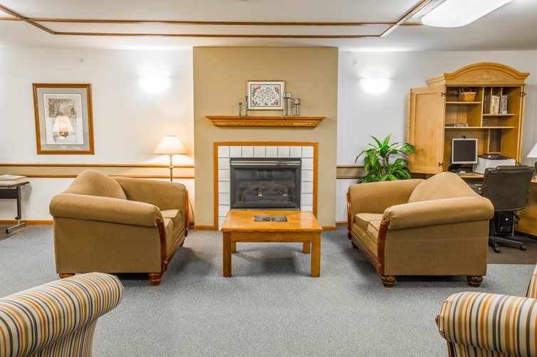 A cozy living room with comfortable sofas and a fireplace.