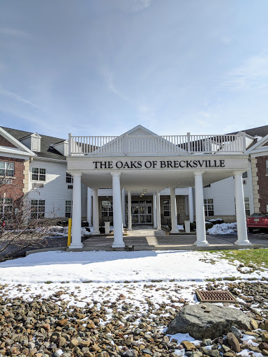 The entrance of The Oaks of Brooksville, a cozy retirement community surrounded by snow.
