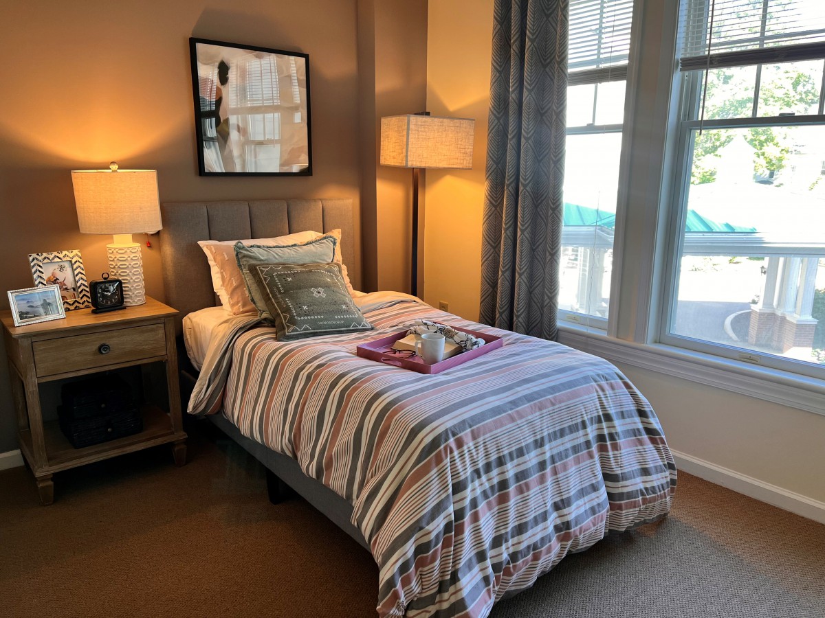 A cozy bedroom with a single bed, soft lighting, and elegant decor.
