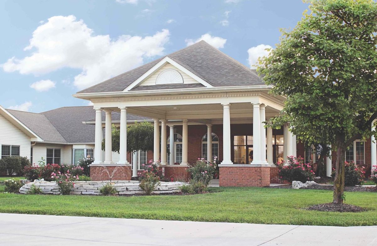 A suburban house with a large porch and white columns.