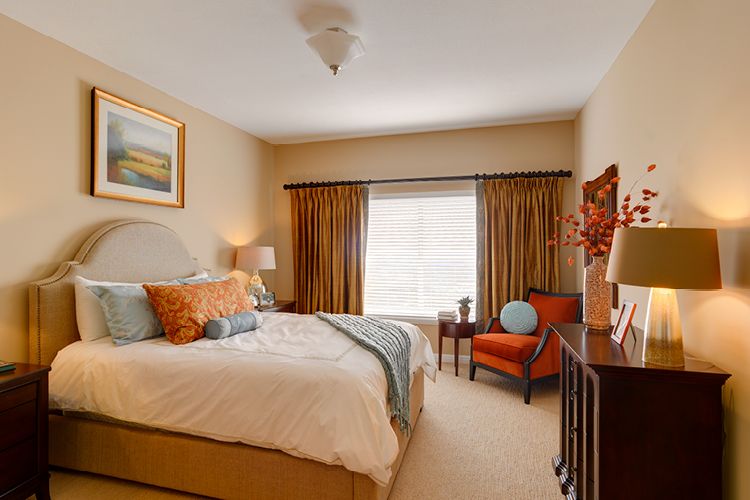 A cozy and elegantly designed bedroom with warm colors and tasteful decor.