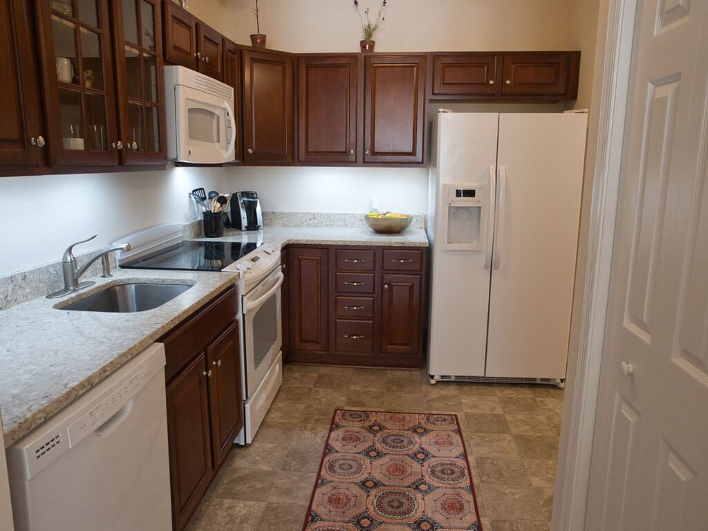 A cozy kitchen with wooden cabinets and modern appliances.