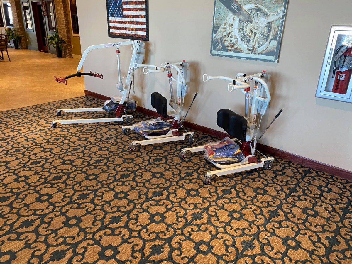 Exercise equipment placed in a lobby area with patterned carpeting.