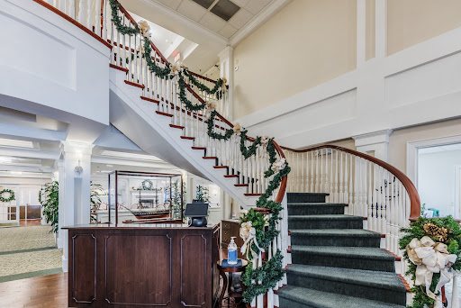 A beautifully decorated staircase adorned with garlands, showcasing an elegant interior for the holiday season.