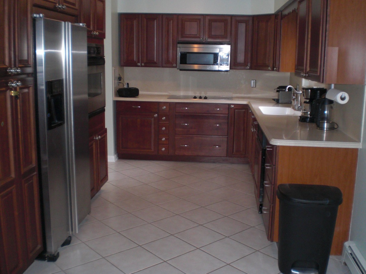 A modern kitchen with wooden cabinets and stainless steel appliances.