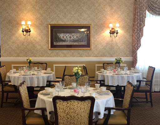 A beautifully arranged dining room featuring elegant tables and chairs, enhanced by tasteful decor.