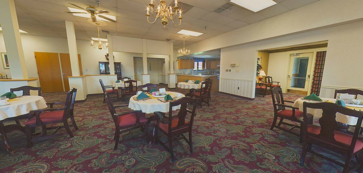 A cozy dining area with elegantly set tables and traditional decor.