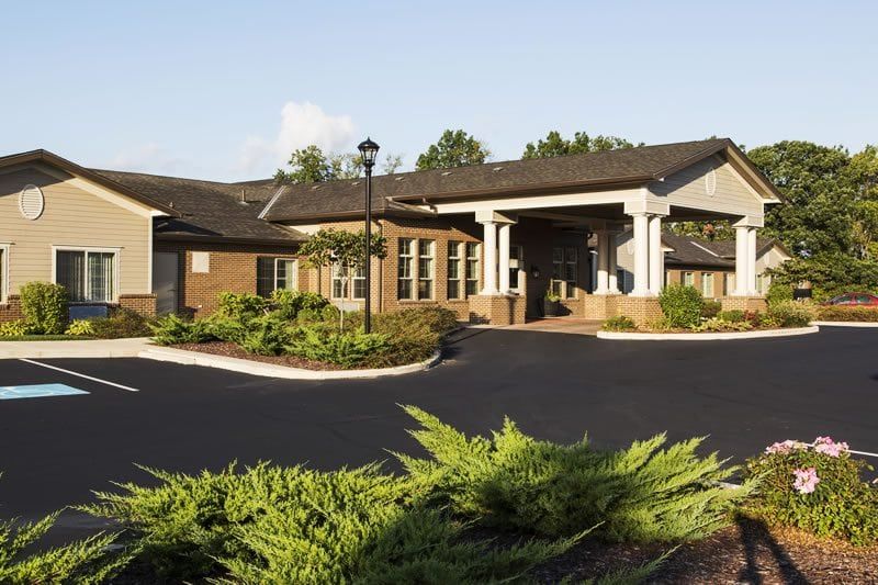 A scenic view of a residential building surrounded by well-maintained landscaping.
