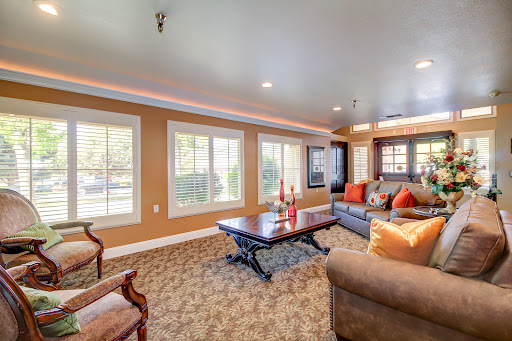 A spacious and inviting living room filled with natural light, featuring comfortable seating and modern decor.