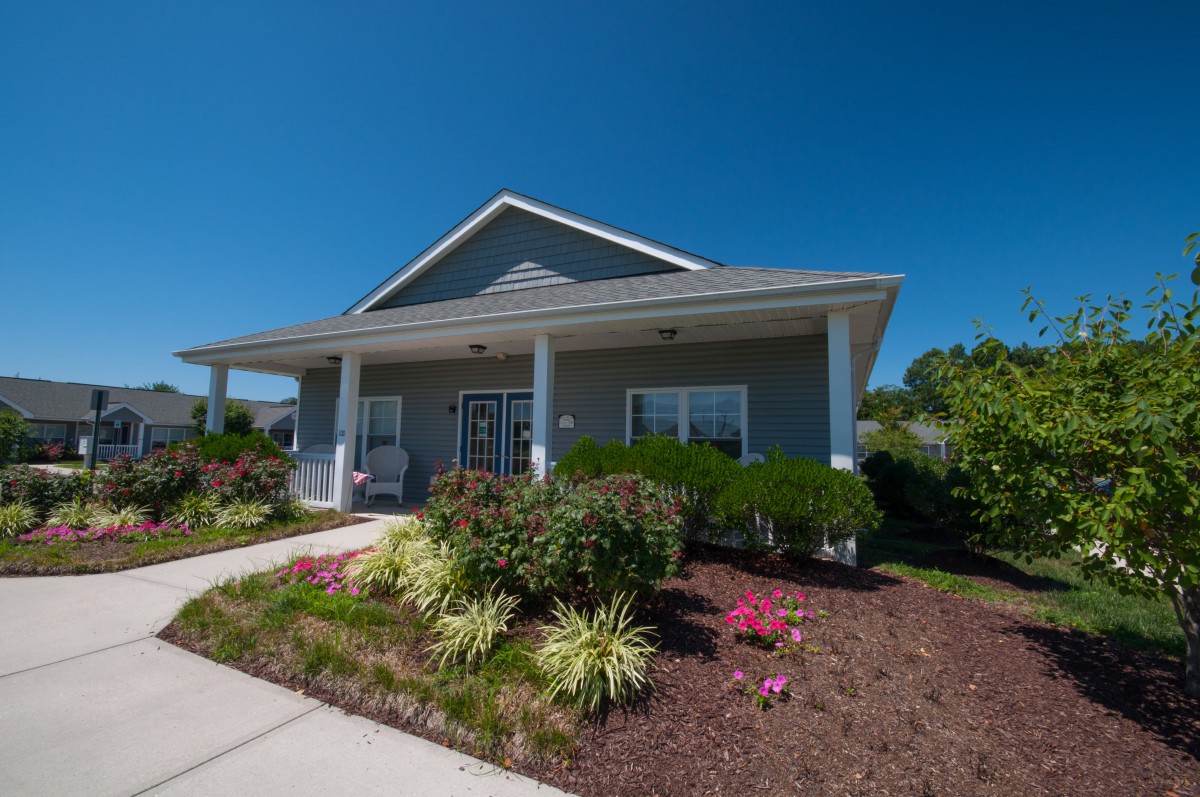 A single-story house with a well-maintained garden and a covered front porch.