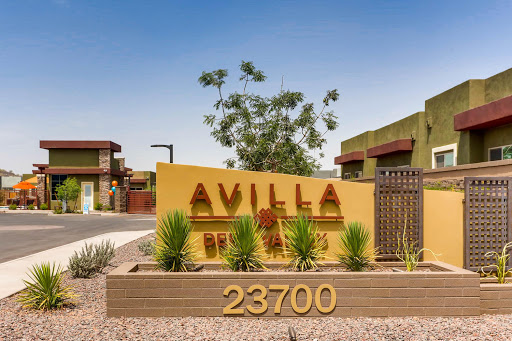 Entrance sign of the Avilla apartment complex, featuring modern design and landscaping.