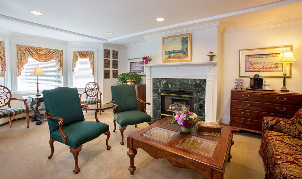 A cozy living room featuring classic furniture and a fireplace.
