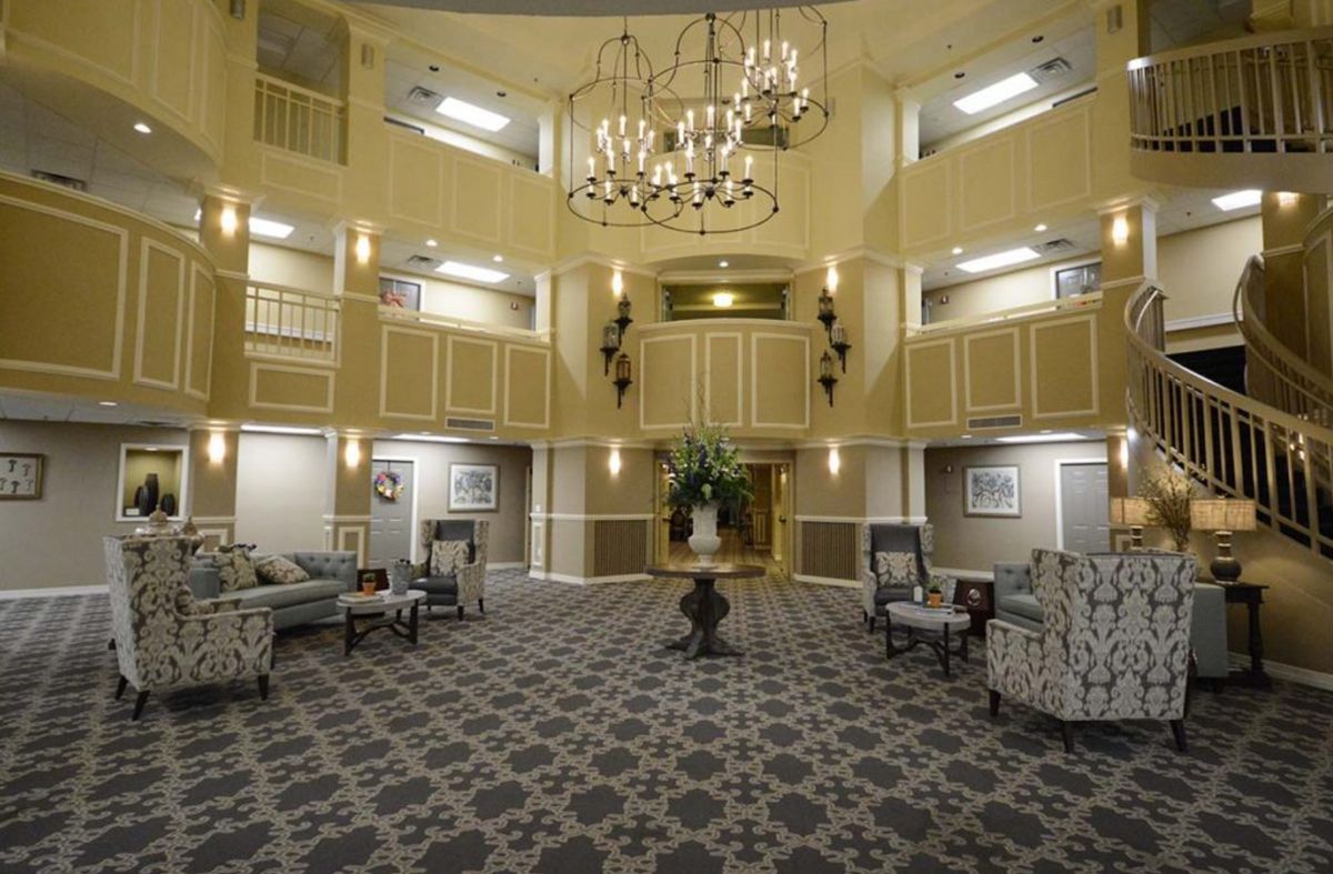 A luxurious hotel lobby featuring elegant chandeliers, comfortable seating, and sophisticated decor.