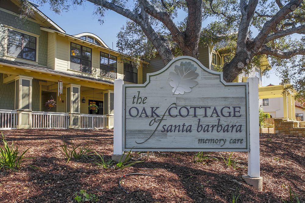 The Oak Cottage of Santa Barbara, a welcoming two-story building surrounded by trees.