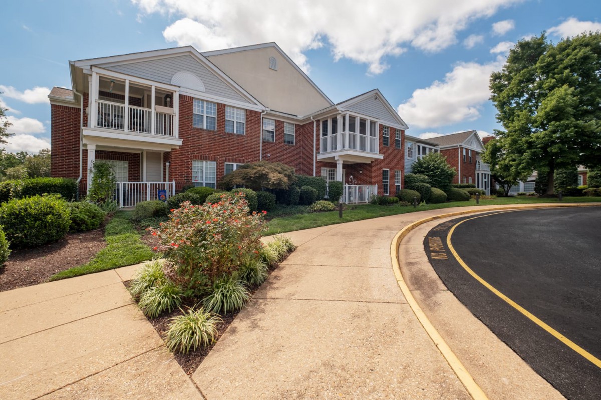 A view of a residential apartment building with balconies and landscaped surroundings.