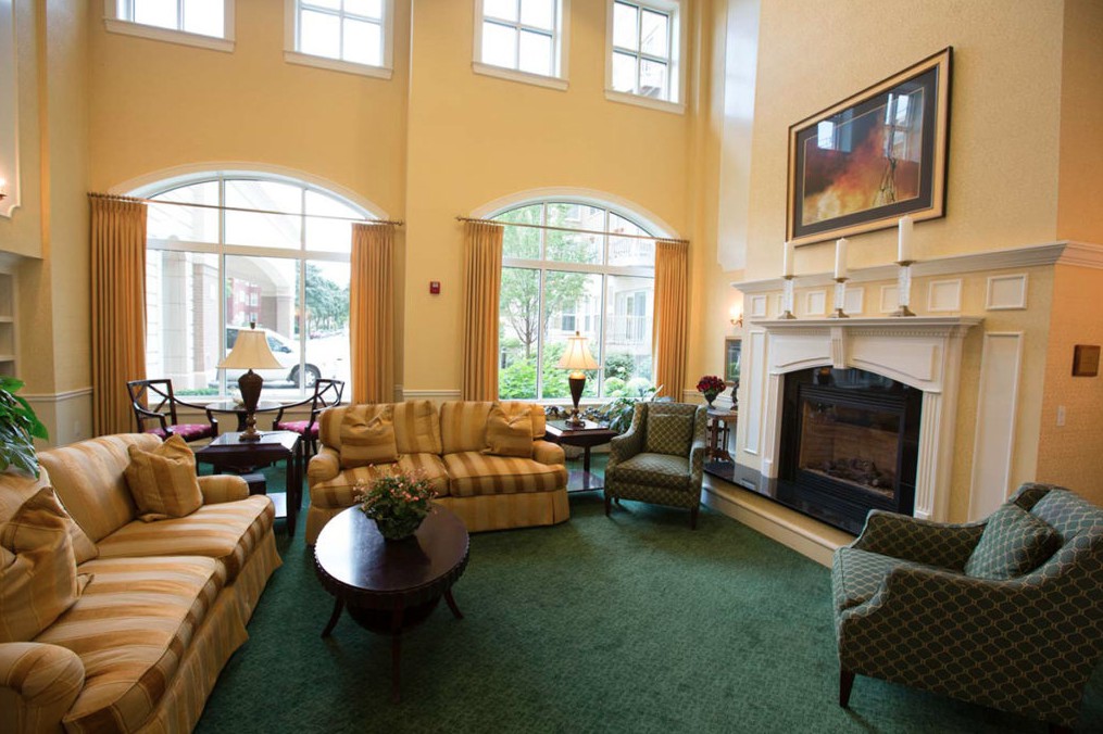 A cozy living room with comfortable seating and a warm fireplace.