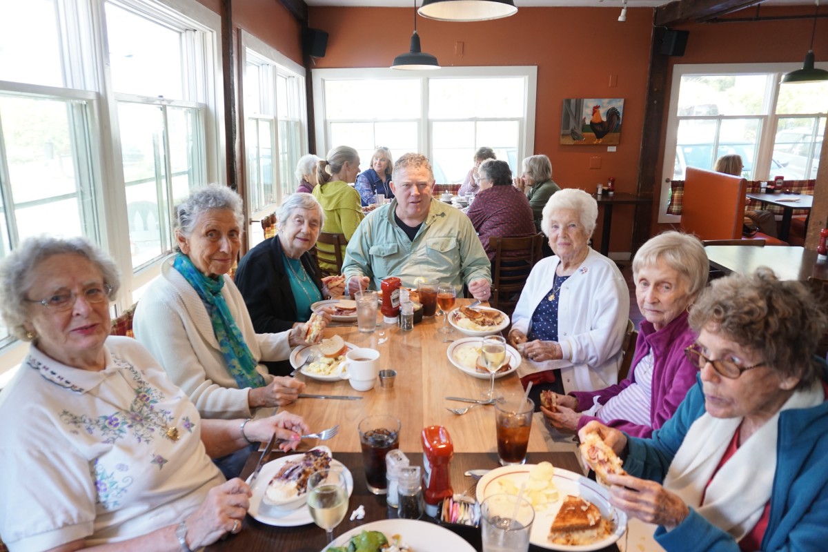 A group of people enjoying a meal together at a restaurant.