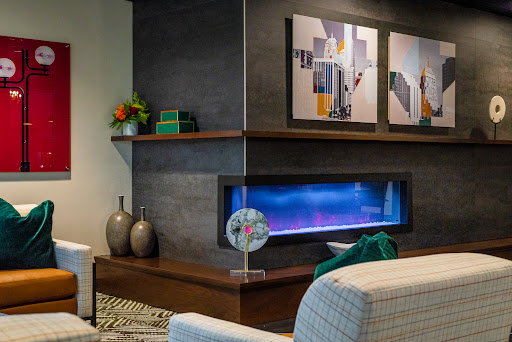 A stylish modern living room featuring a sleek fireplace and contemporary artwork.