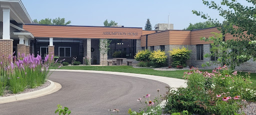 A view of a modern building surrounded by landscaped greenery.