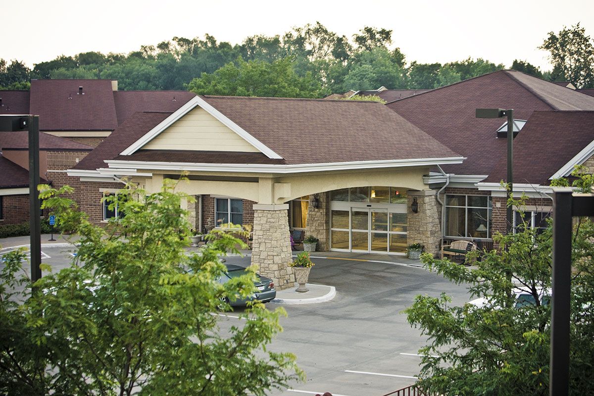 A residential building with a welcoming entrance surrounded by greenery.