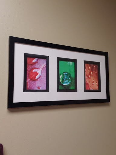A contemporary framed triptych featuring vibrant abstract designs.