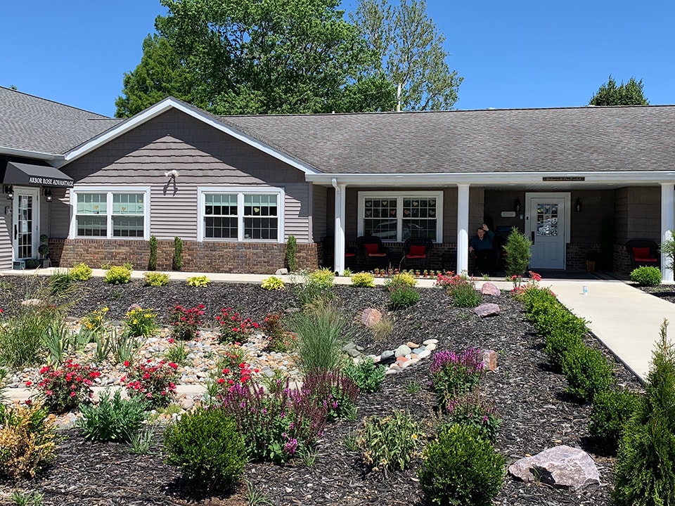 A single-story house with a beautifully landscaped garden in the foreground.