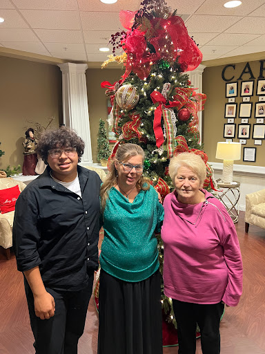A joyful family gathering in front of a beautifully decorated Christmas tree.