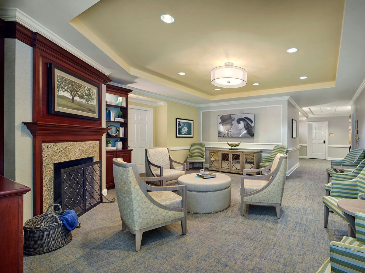 A modern living room with a cozy seating area, fireplace, and elegant interior design.
