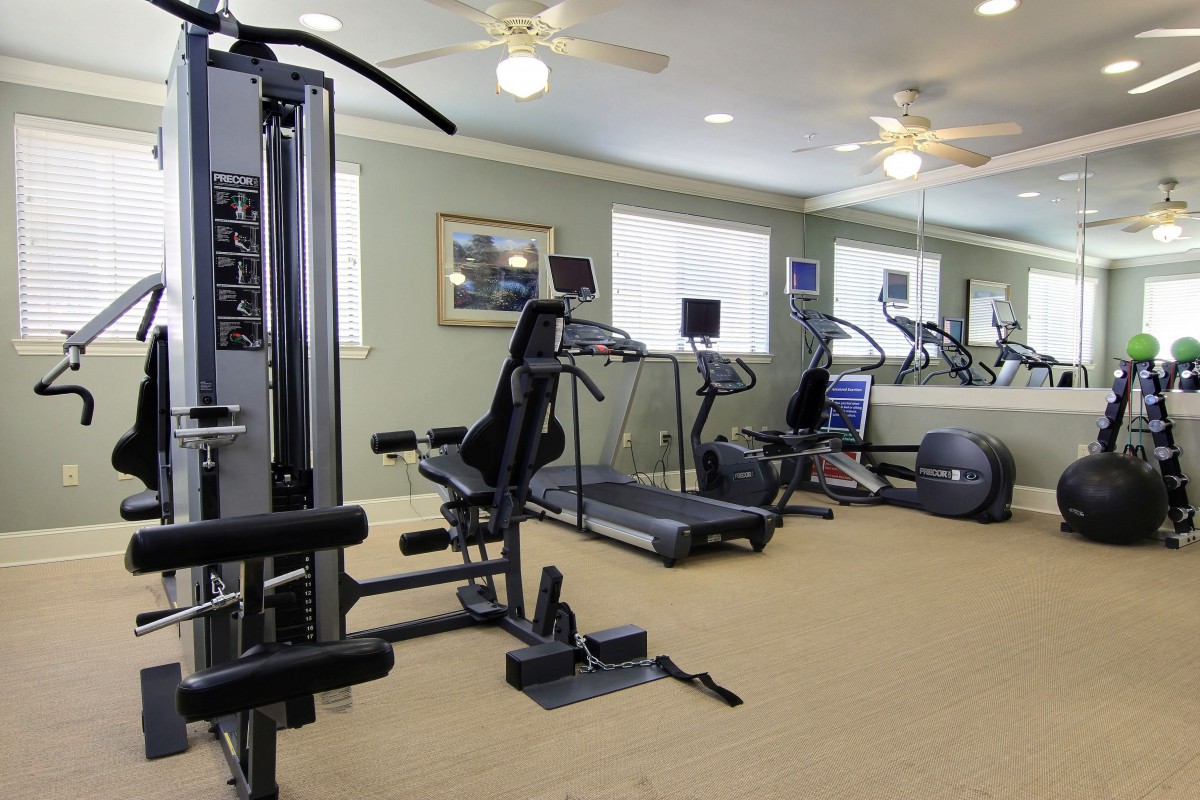A well-equipped home gym featuring treadmills and weight machines.
