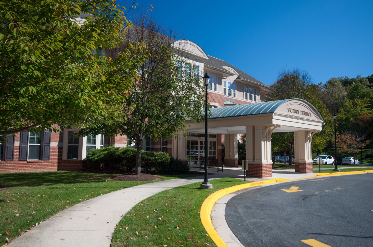 A building entrance with a covered walkway on a sunny day.