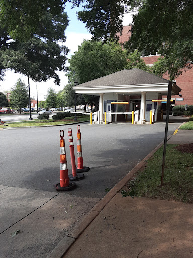 The entrance to a building with traffic cones indicating a lane restriction.