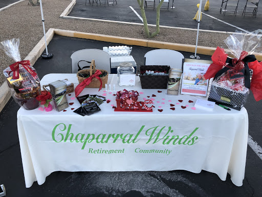 A promotional booth for Chapparal Winds, showcasing community engagement materials and offerings.