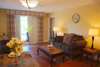 A cozy living room with a sofa, coffee table, and decorative lamps.