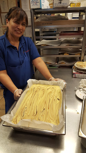A chef preparing a delicious dessert in the kitchen.