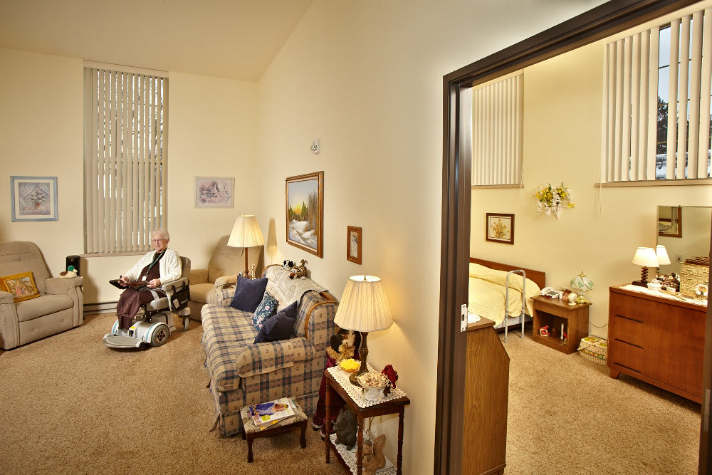 A cozy living space with a connected bedroom, featuring comfortable seating and warm lighting.