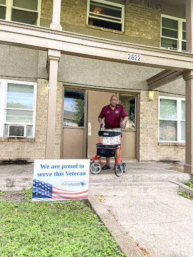 A proud moment in supporting our veterans, as a community member is seen outside their apartment with a mobility aid.