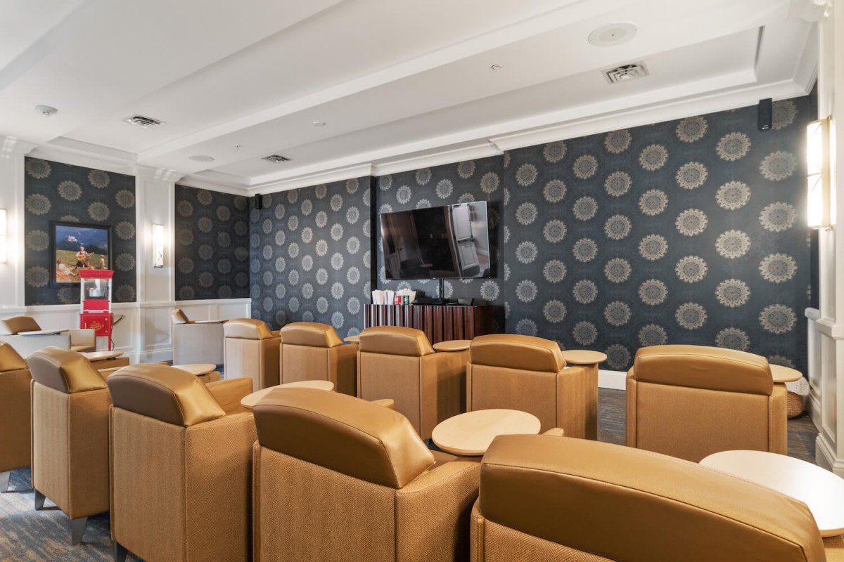 A stylish home theater with comfortable leather seating and a large television.