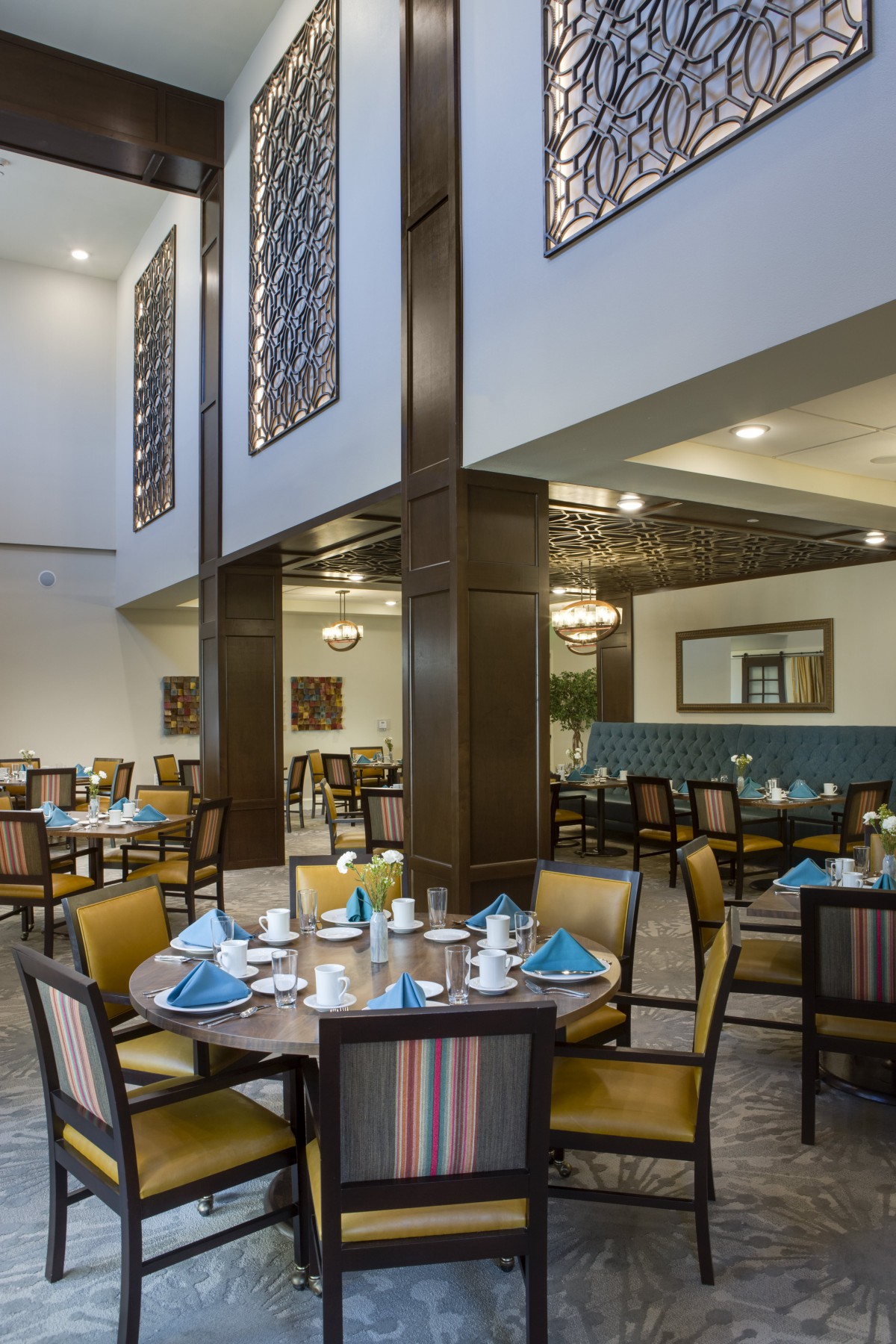 A spacious and elegantly designed restaurant dining area with neatly arranged tables and chairs.