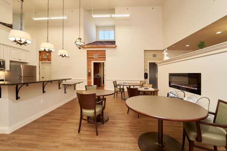 A modern dining room with elegant furniture and warm lighting.